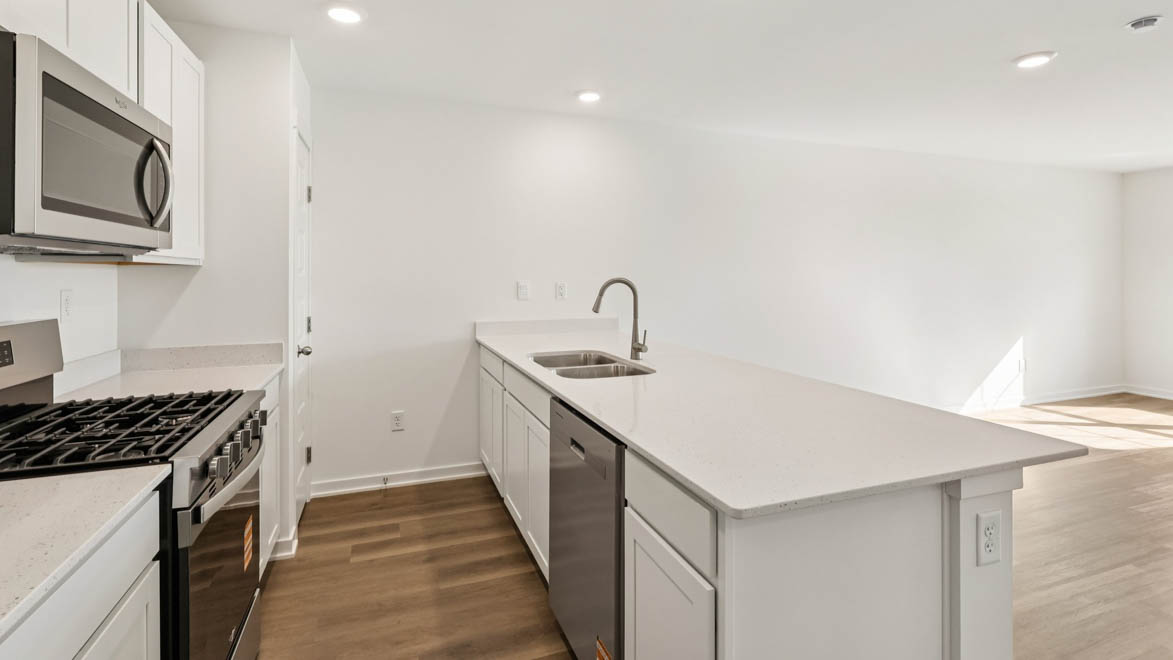 open concept kitchen with spacious island and white cabinets
