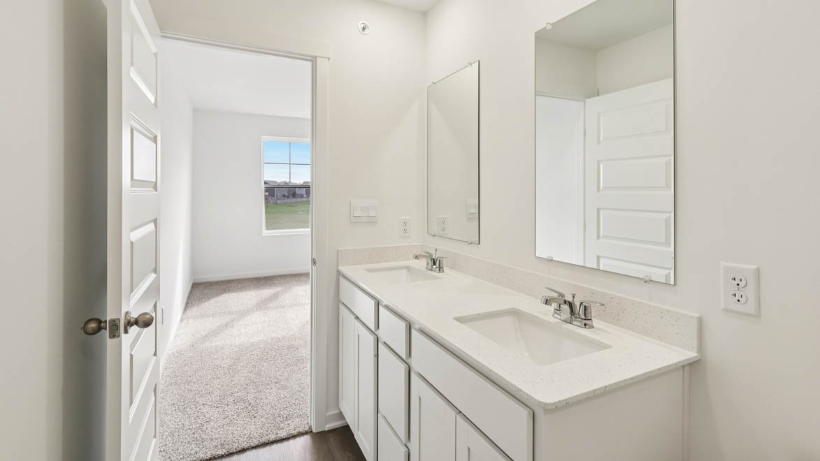 Primary bathroom with dual sinks and walk in shower