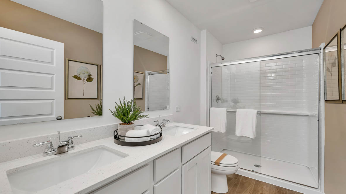 Primary bathroom with dual sinks and walk in shower