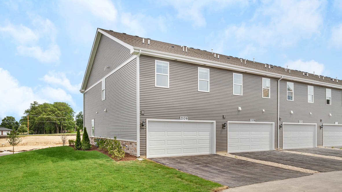 Exterior behind of home with attached two car garage