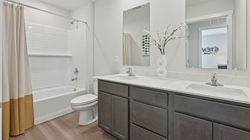Secondary full bathroom with dual sinks