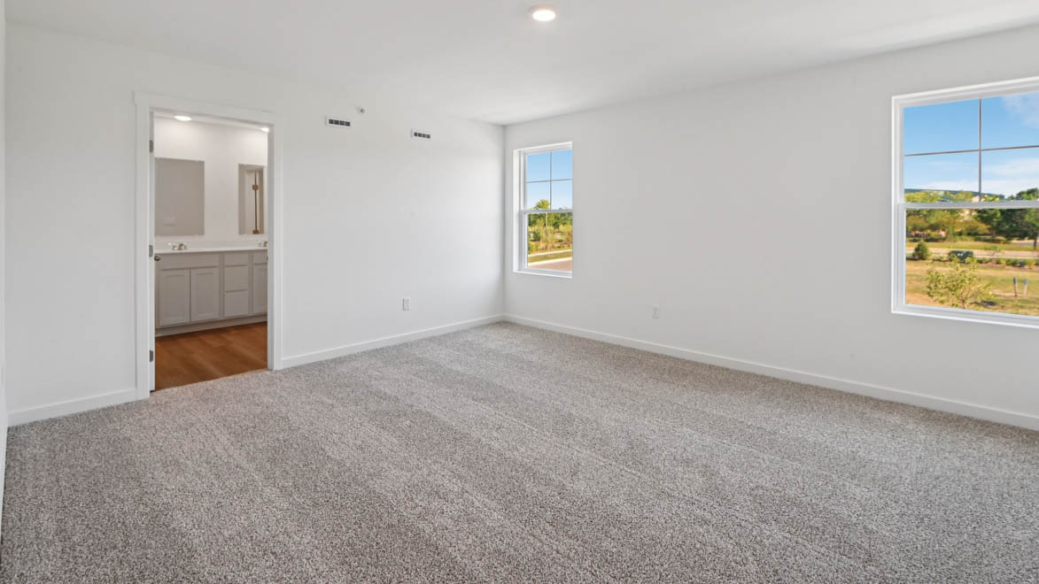 Upstairs primary bedroom with connecting en suite