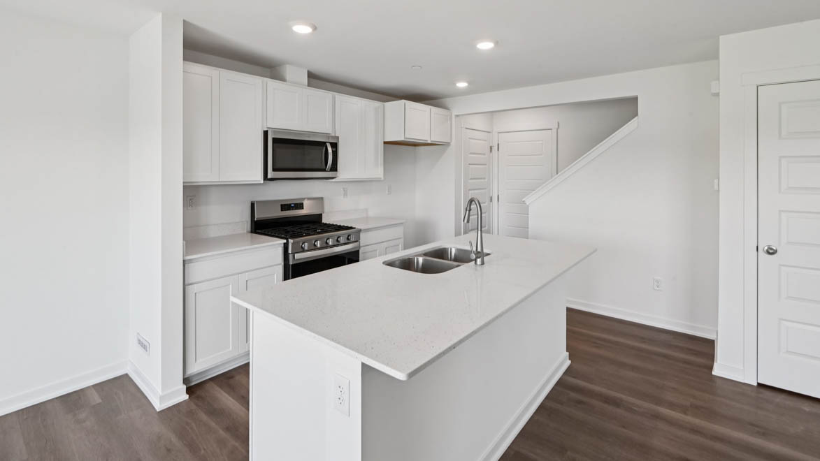 Kitchen with white cabinets and white quartz countertops