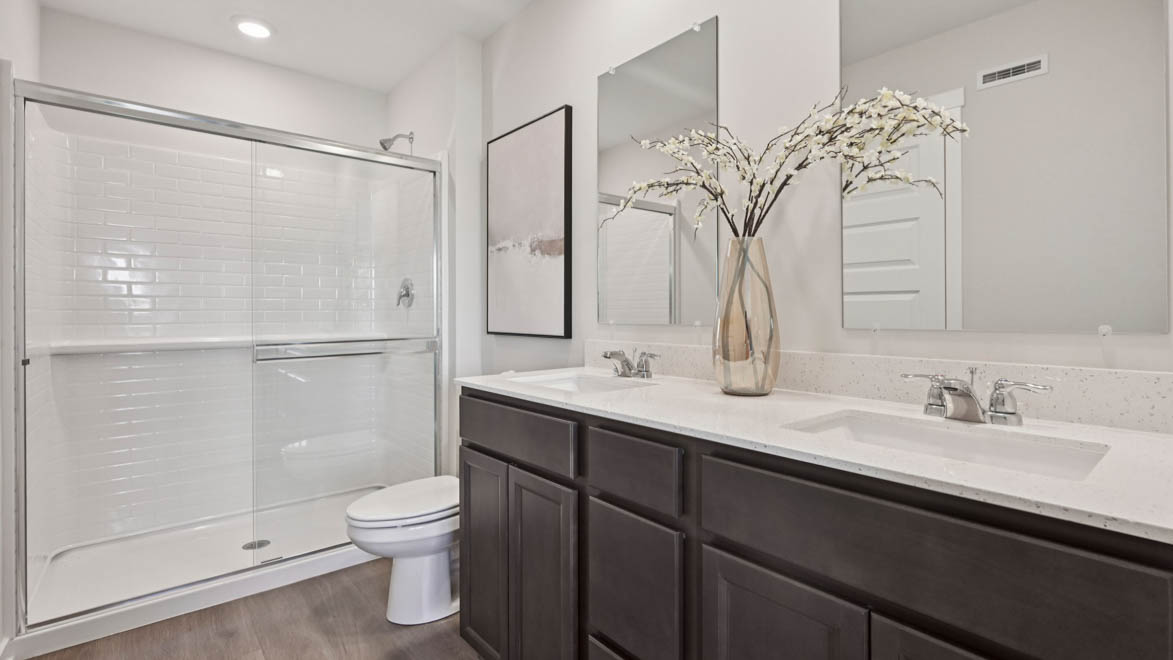 Primary bathroom with walk in shower and dual sinks