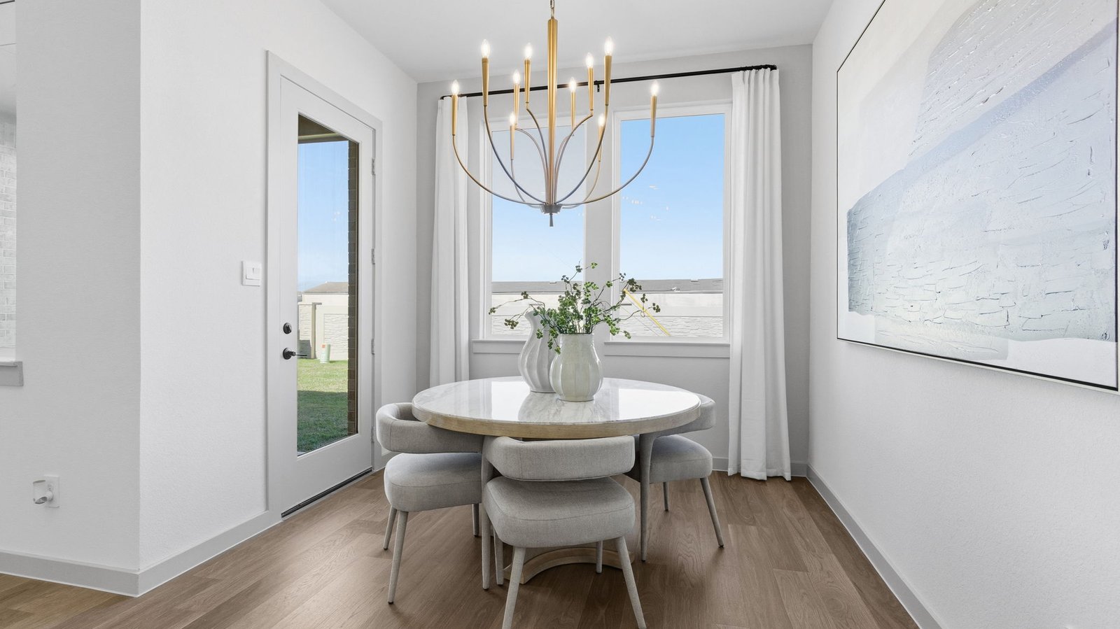 The spacious kitchen features a large island that naturally becomes the heart of the home