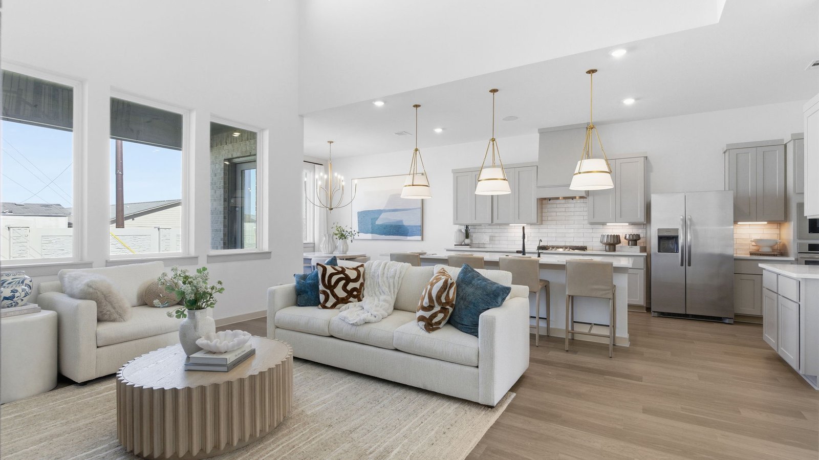 A open-concept living space where the kitchen, family room, and breakfast nook come together