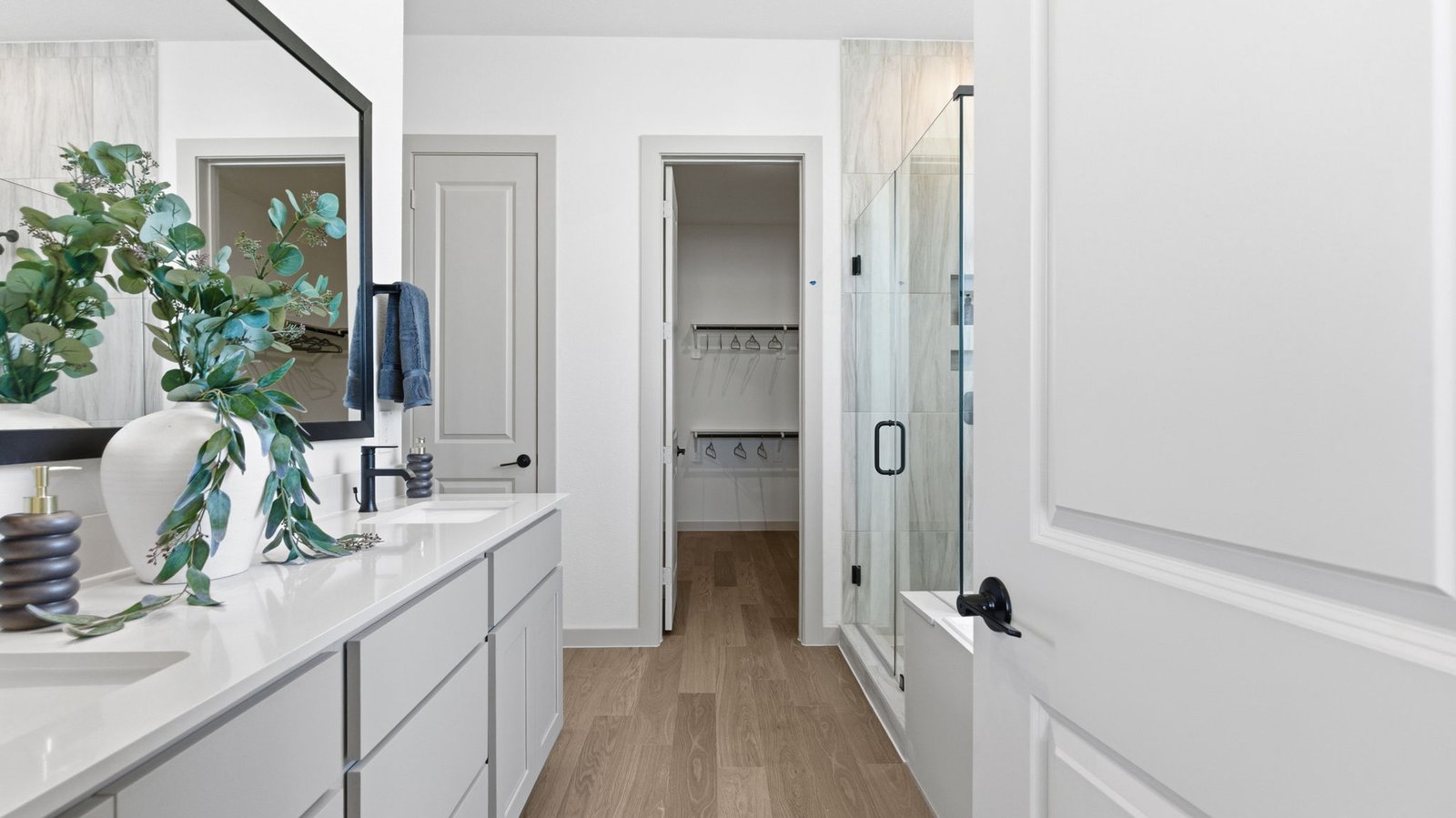 The primary bedroom flows into the en-suite bathroom and walk-in closet