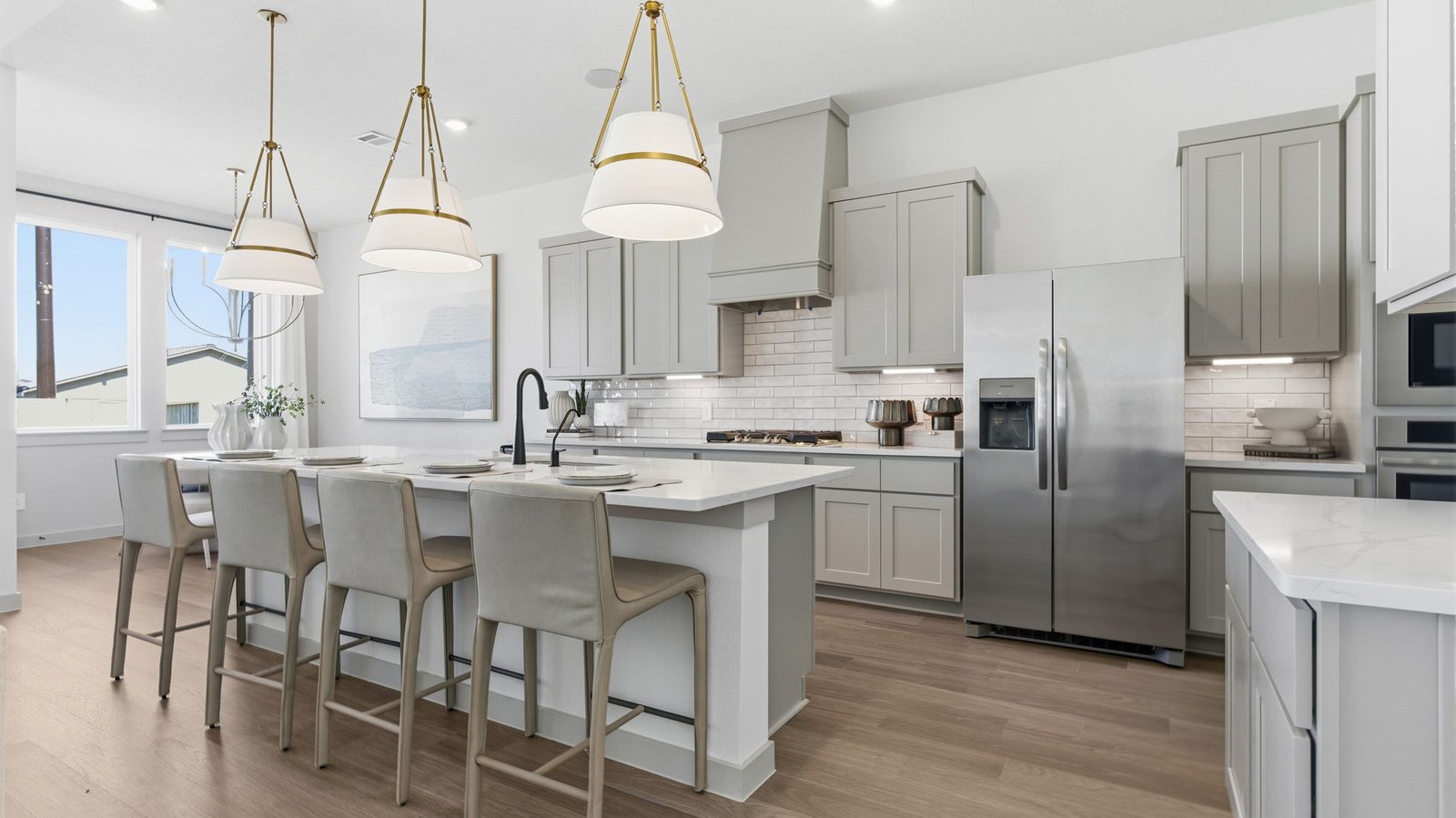 The spacious kitchen features a large island that naturally becomes the heart of the home