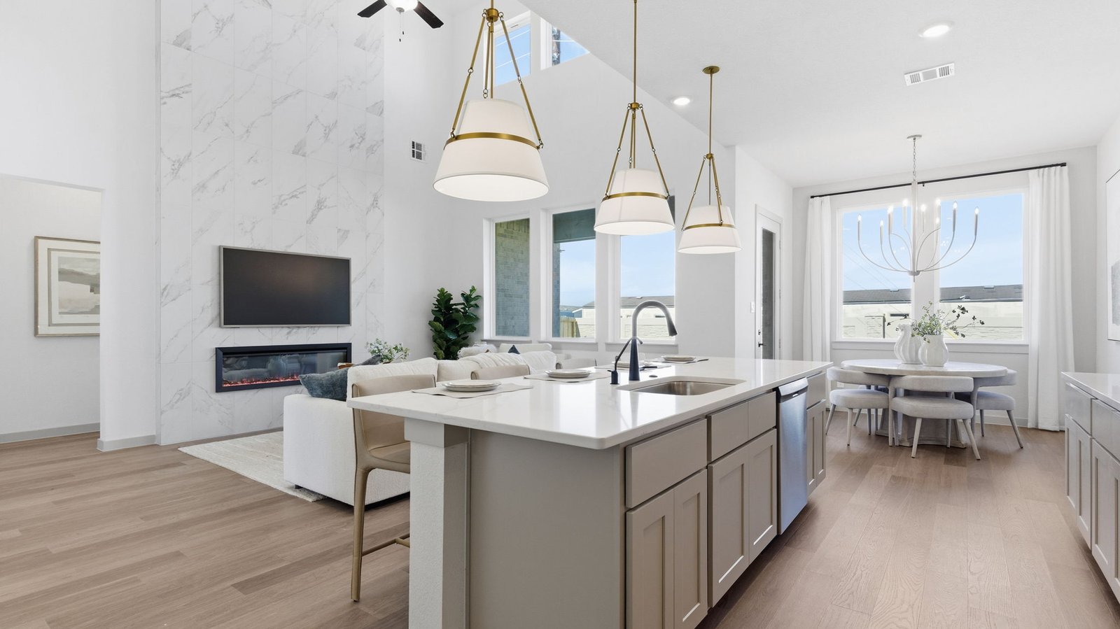The spacious kitchen features a large island that naturally becomes the heart of the home