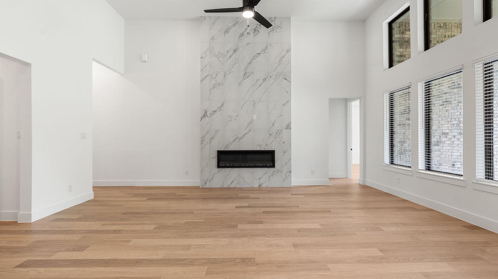 living room with multiple large windows and fireplace