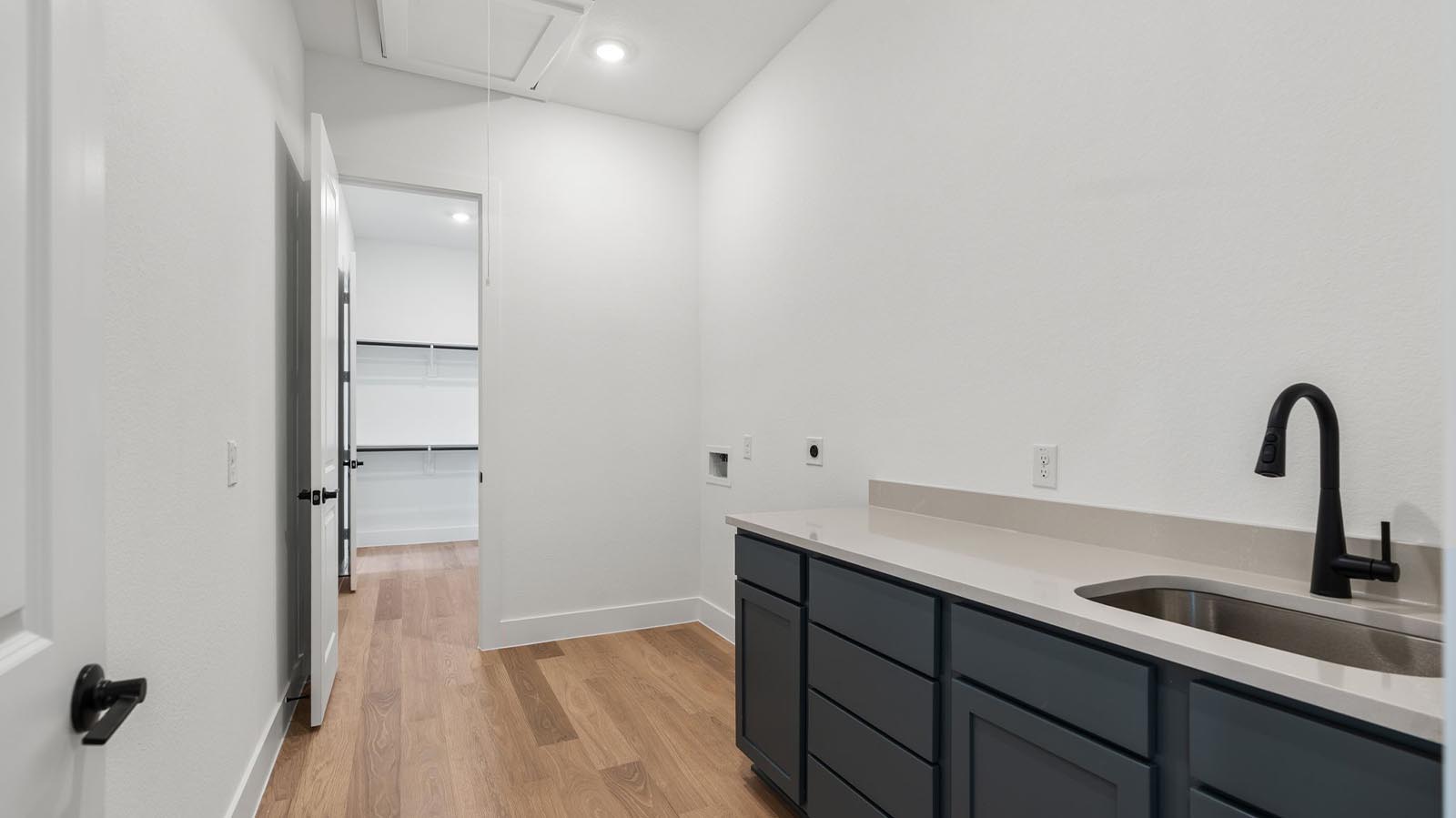 walk in laundry room with sink
