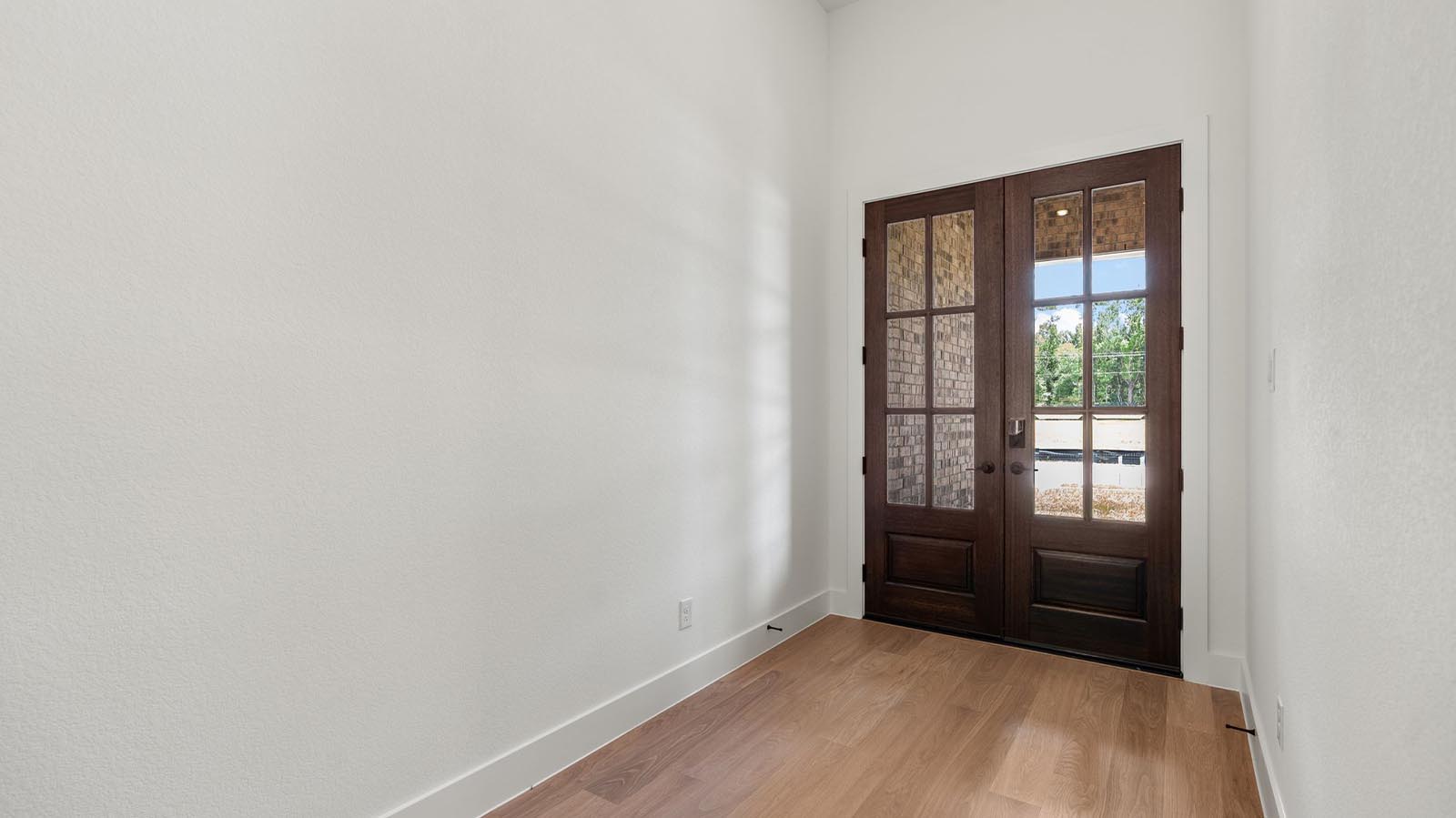 Entry hallway leading to bedrooms and the open concept living and kitchen area.