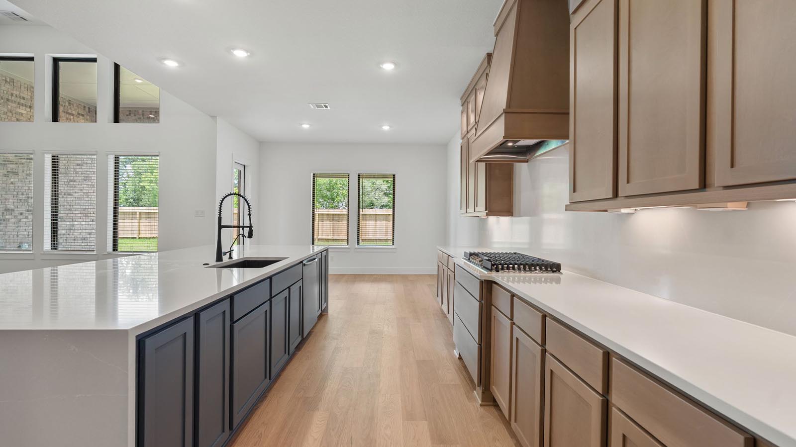 Kitchen island with different color cabinetry and additional space for bar seating