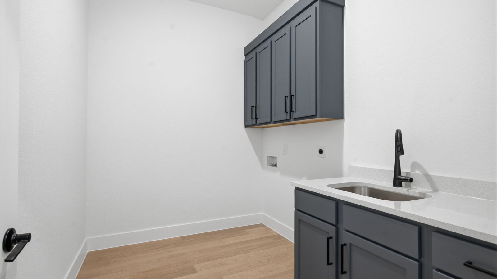 A laundry room featuring a washer and dryer, neatly arranged with ample space for laundry tasks, and storage.