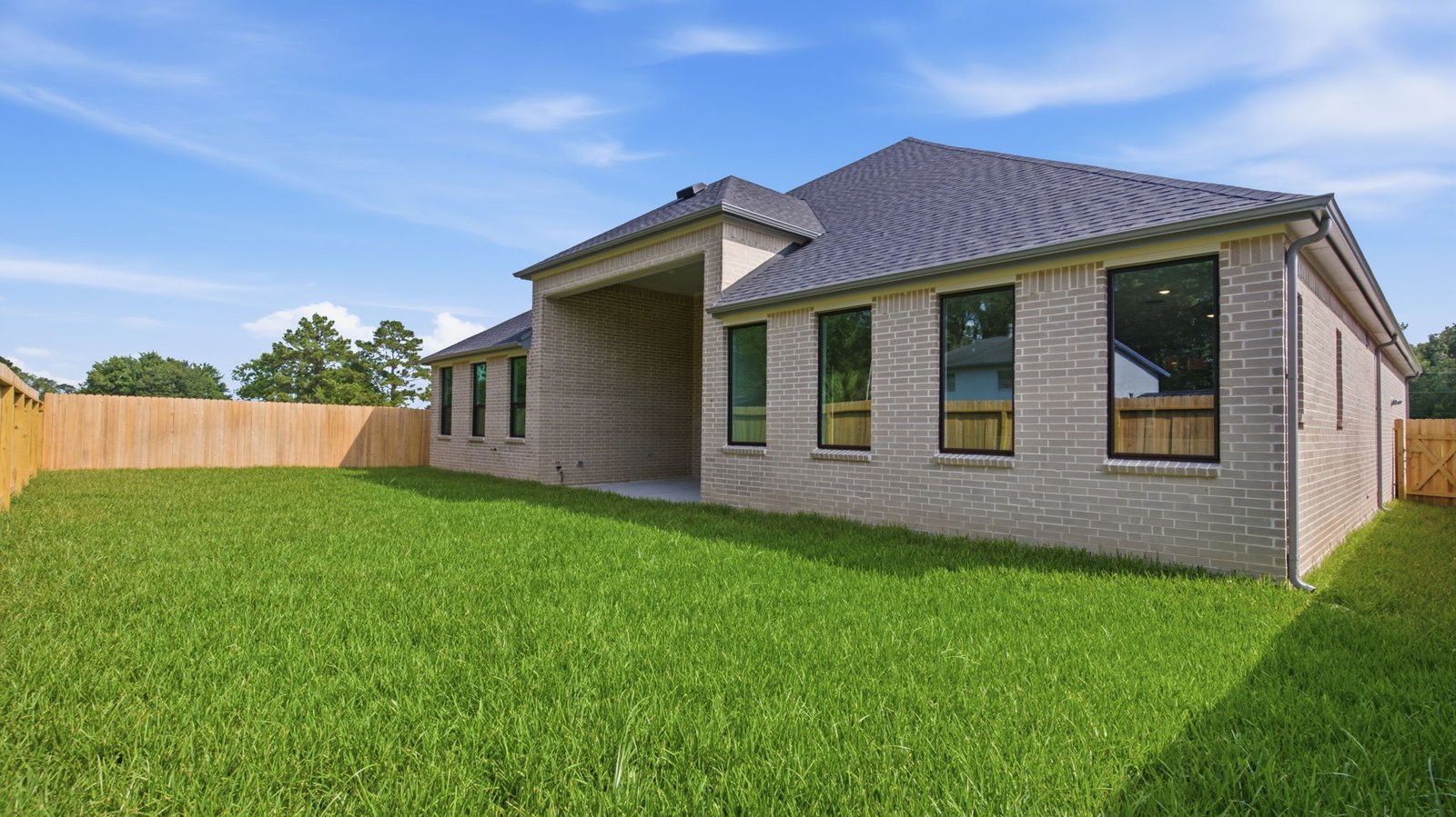 backyard with sod and covered back patio