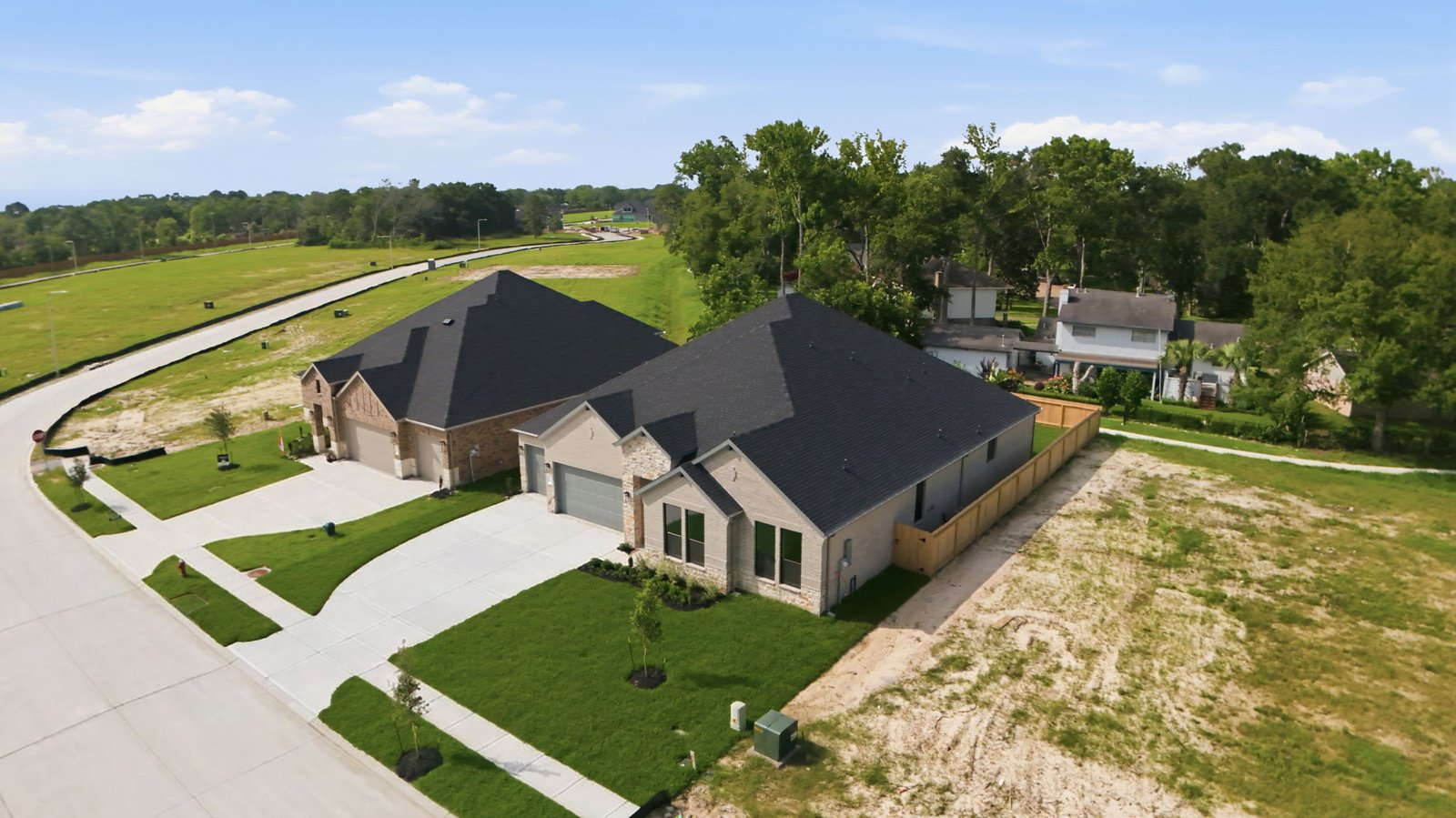 Friendswood Trails one story upscale one story home with modern interior architecture, a covered patio, four bedrooms, three and a half bathrooms and a three car garage