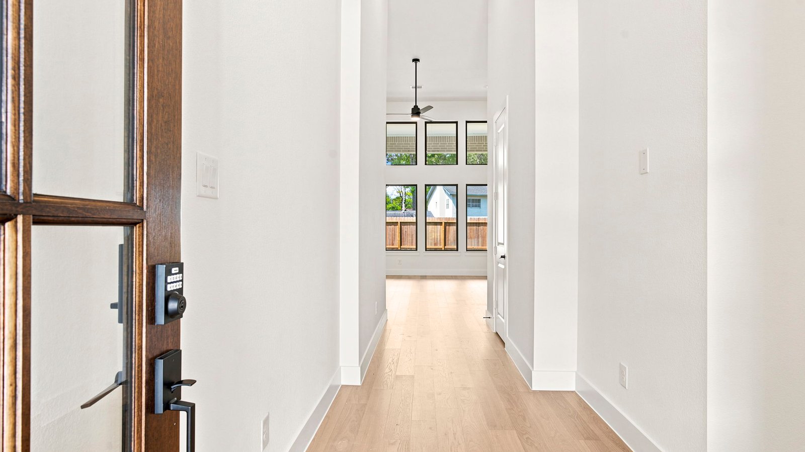 Entry hallway leading to bedrooms and the open concept living and kitchen area.