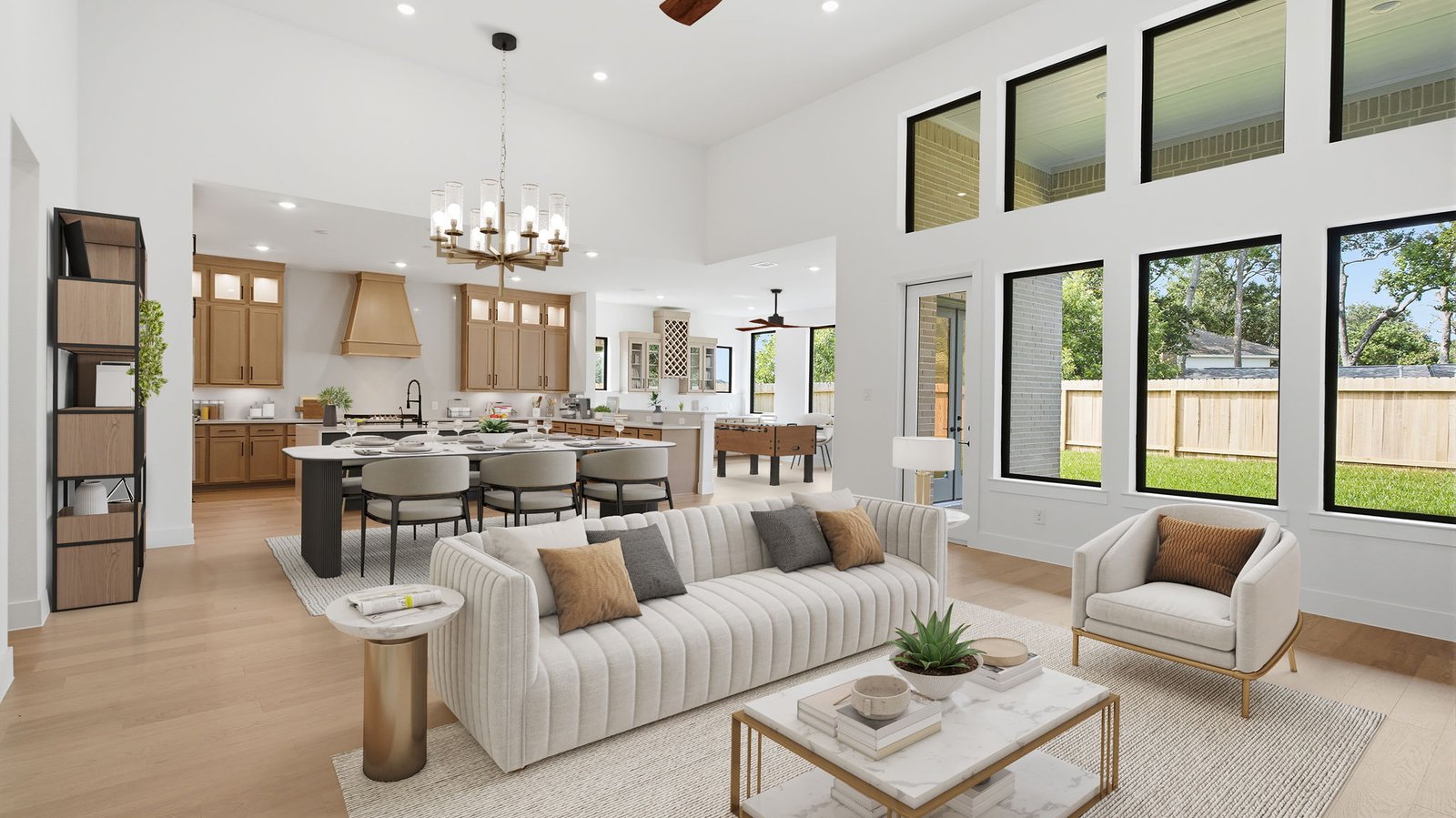 Elegant living room with soaring ceilings, a cozy electric fireplace, open-concept design, and seamless flow into a chef-inspired kitchen.