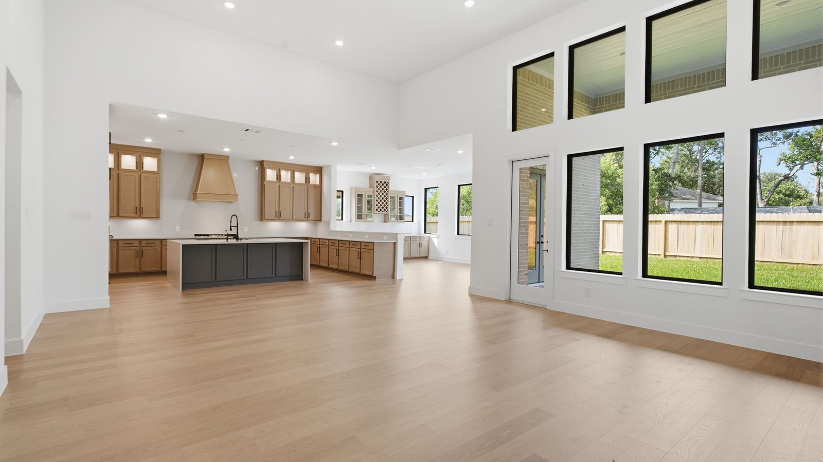open concept living room with tall ceilings, multiple windows, and fire place