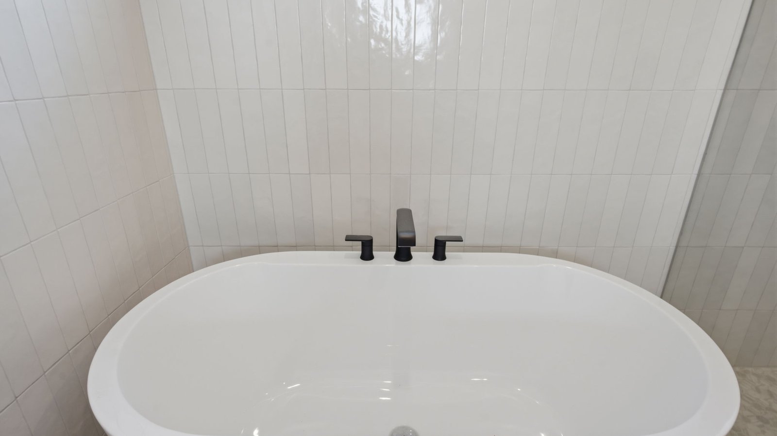 Luxurious primary bathroom with dual vanities, a soaking tub, and separate glass-enclosed walk in shower