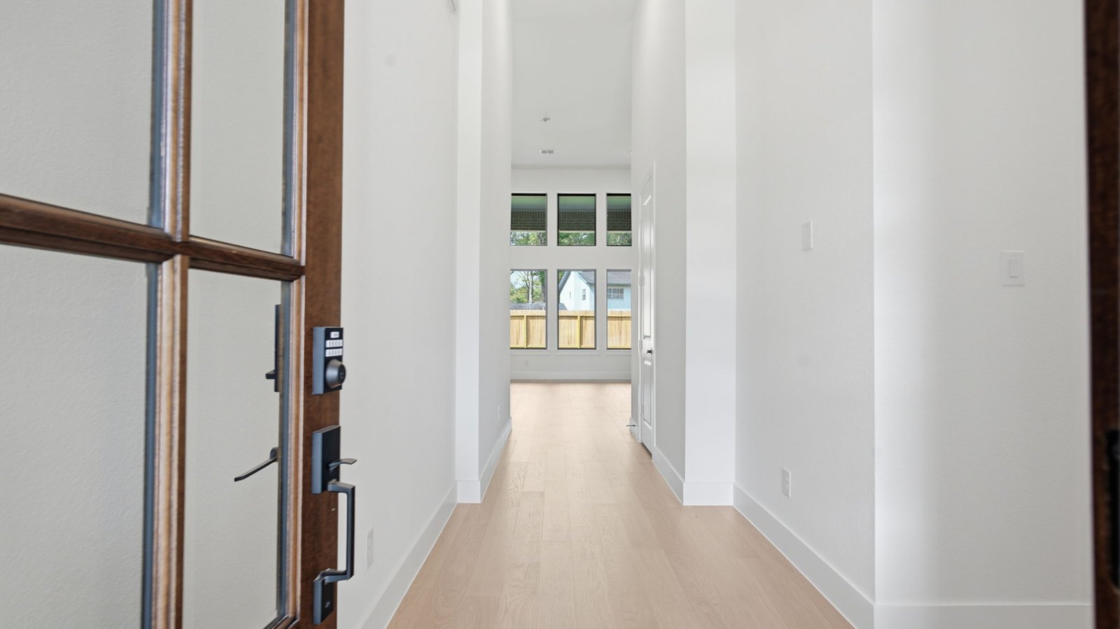 Entry hallway leading to bedrooms and the open concept living and kitchen area.