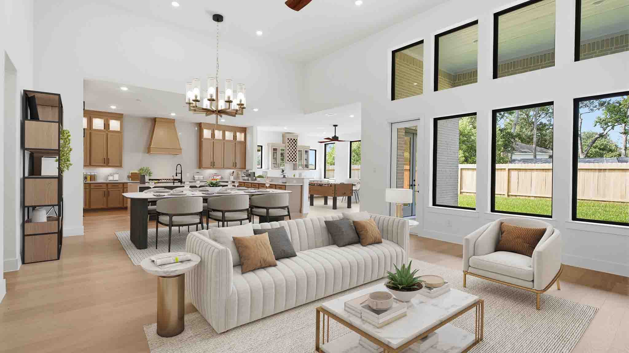Elegant living room with soaring ceilings, a cozy electric fireplace, open-concept design, and seamless flow into a chef-inspired kitchen.