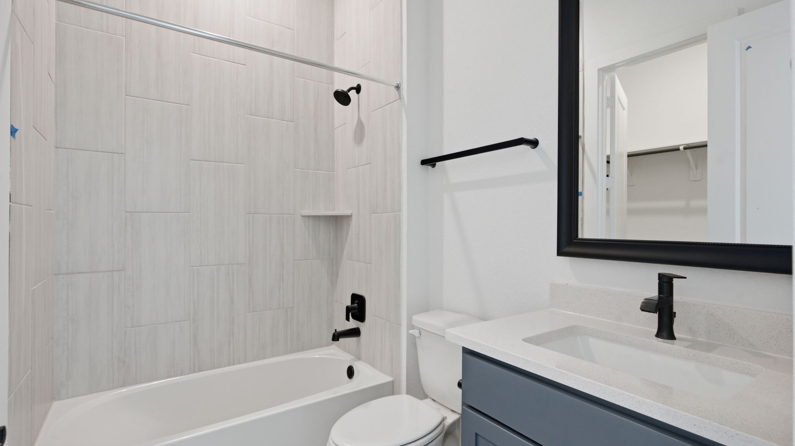 A secondary bathroom with a standing tub, one sink vanity, and a window for natural lighting
