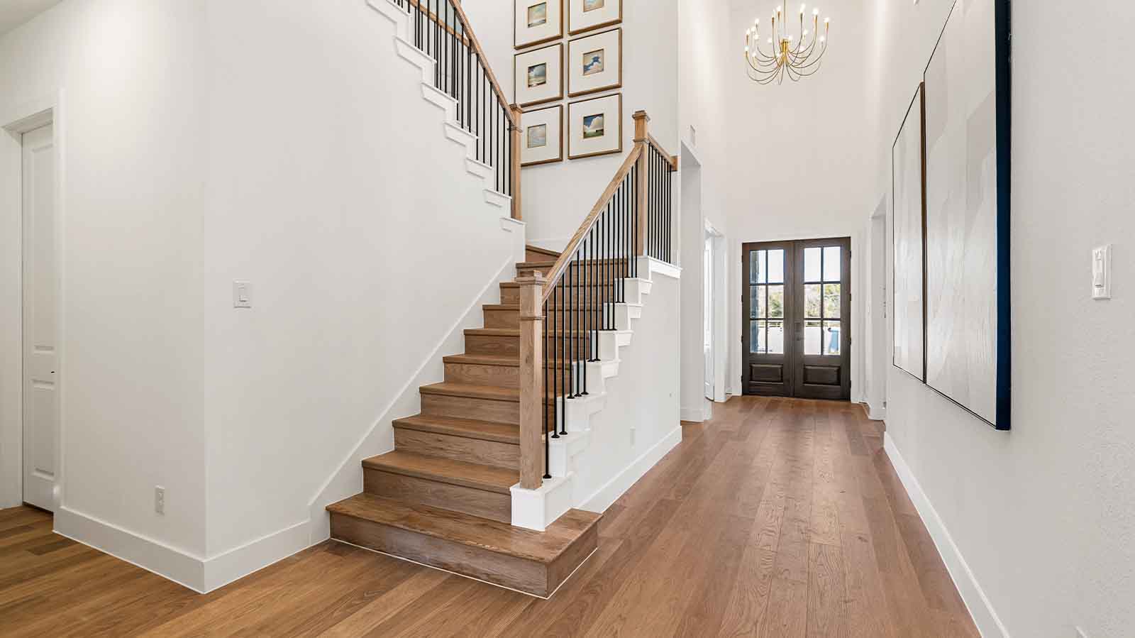 Entry hallway leading to bedrooms and the open concept living and kitchen area.