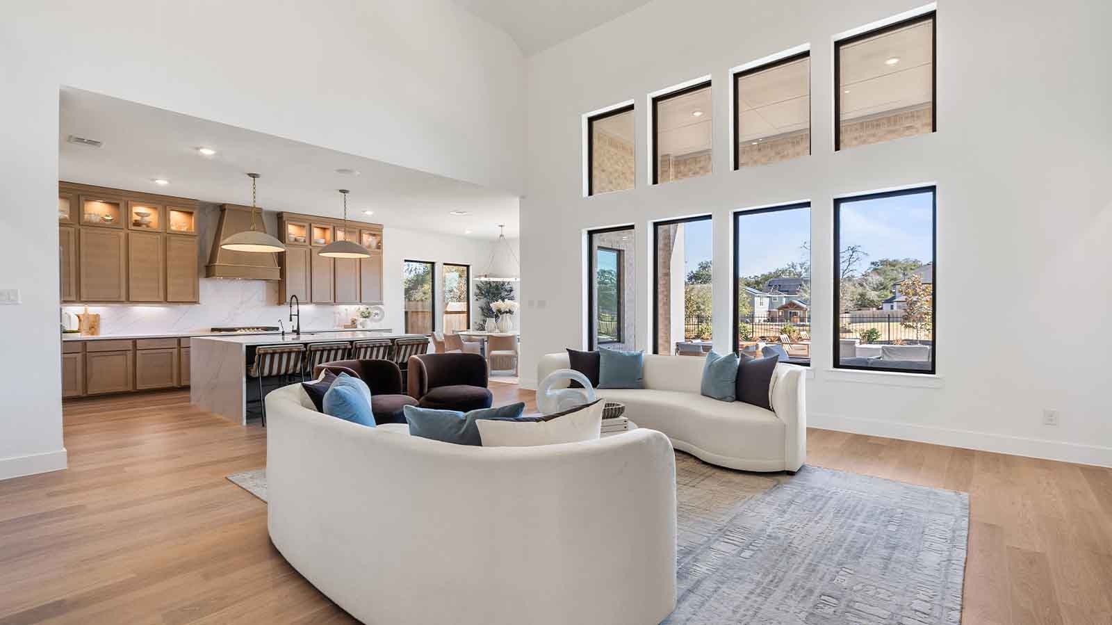open concept living room with multiple windows and tall ceilings