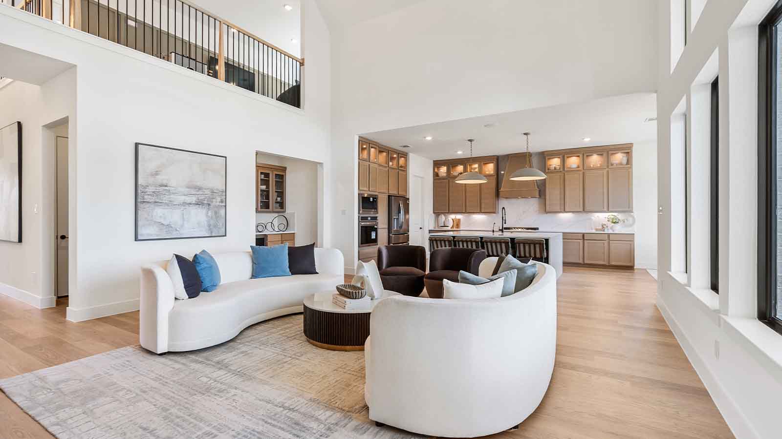 open concept living room with multiple windows and tall ceilings
