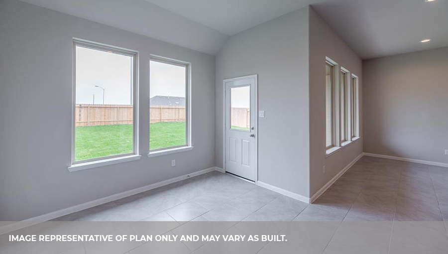 Open concept living and dining room with four windows and a back patio door