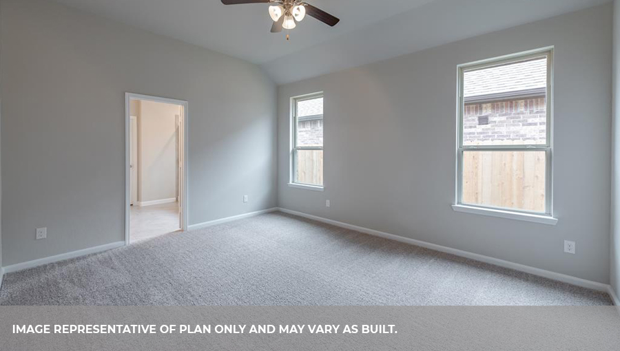 Spacious primary bedroom with two large windows