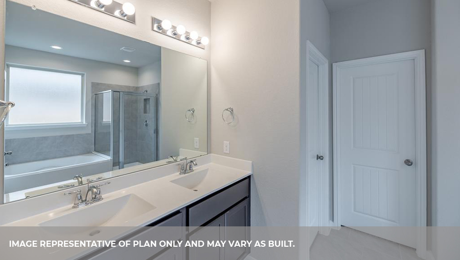Primary bathroom vanity with two sinks and a large mirror