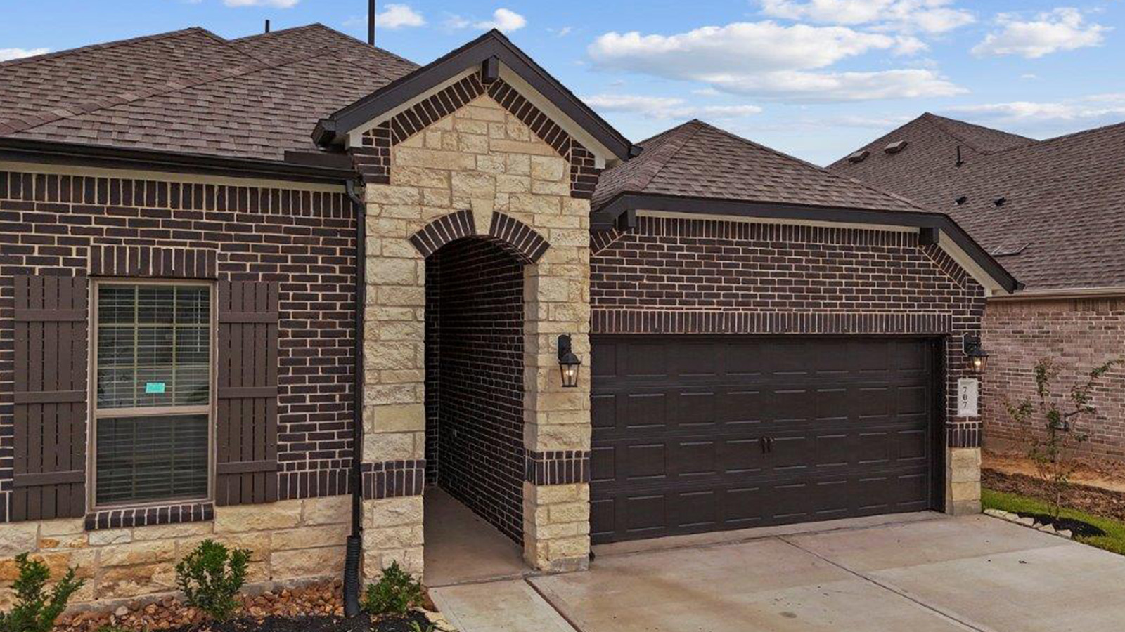 Single story brick home with a two car garage