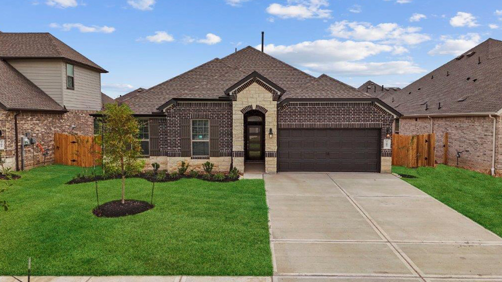 Single story brick home with a two car garage