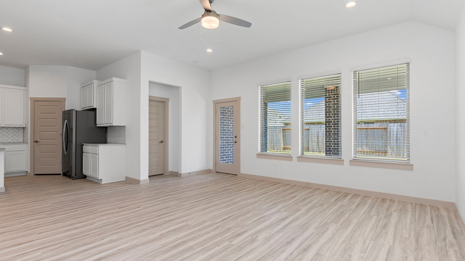 Spacious living room with three large windows