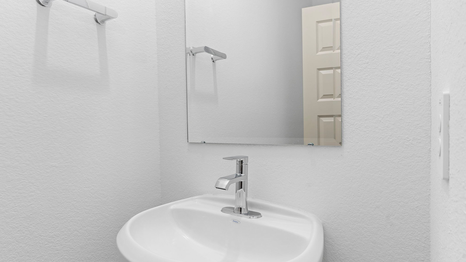 Half bath with one vanity and a mirror