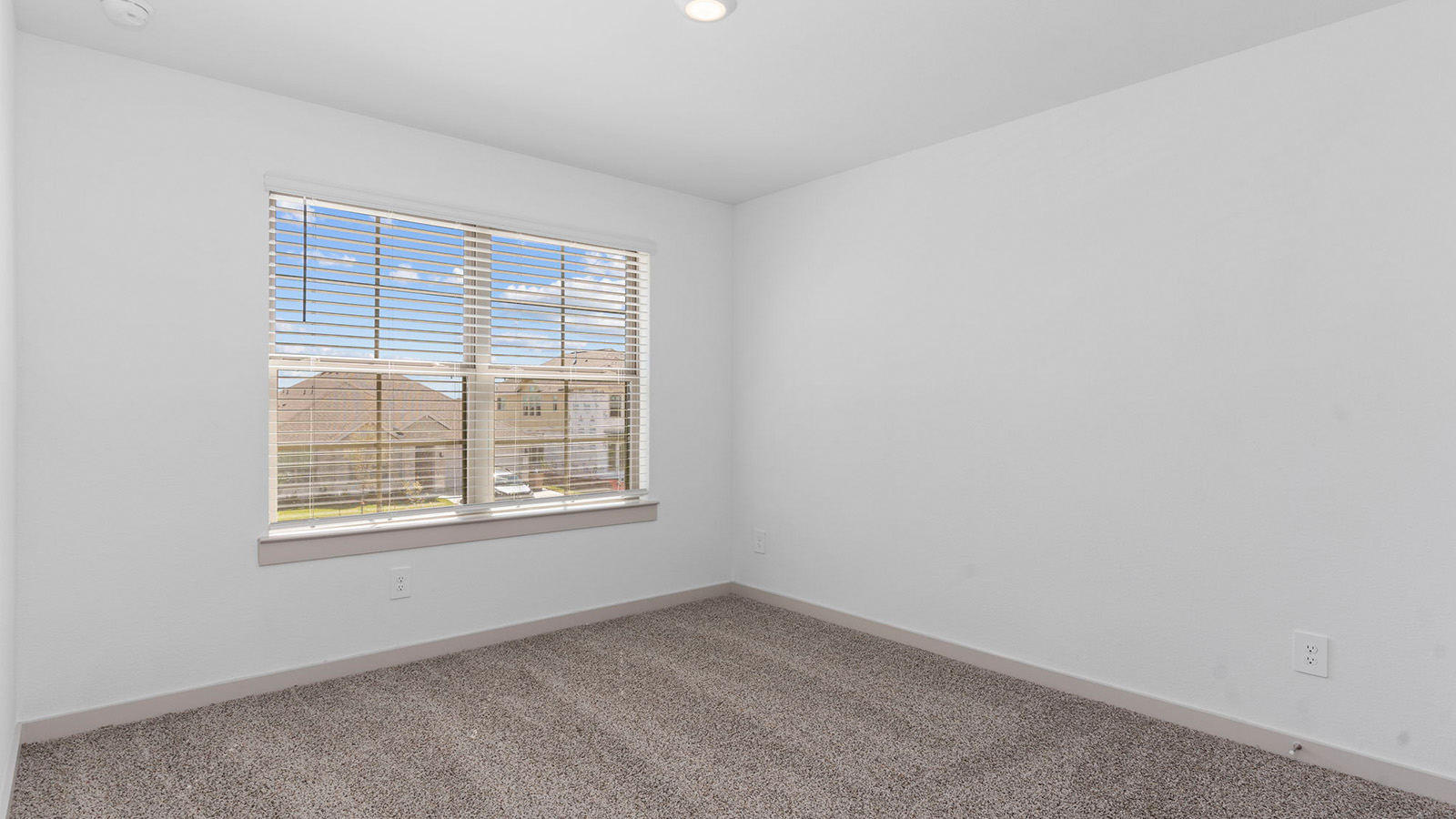 Secondary bedroom with two large windows