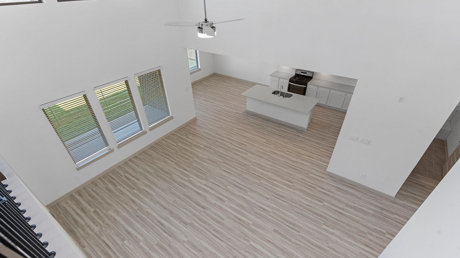 View looking down from second floor game room into the living room