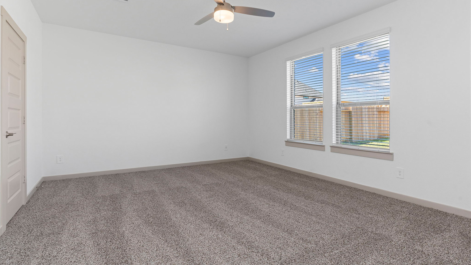 Primary bedroom with two large windows