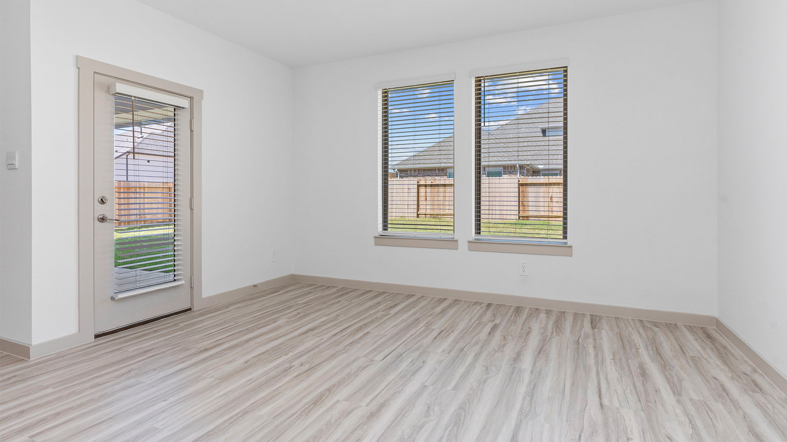 Dining room with two large windows and a back patio door