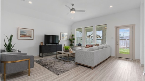 Living room with three windows and back patio door