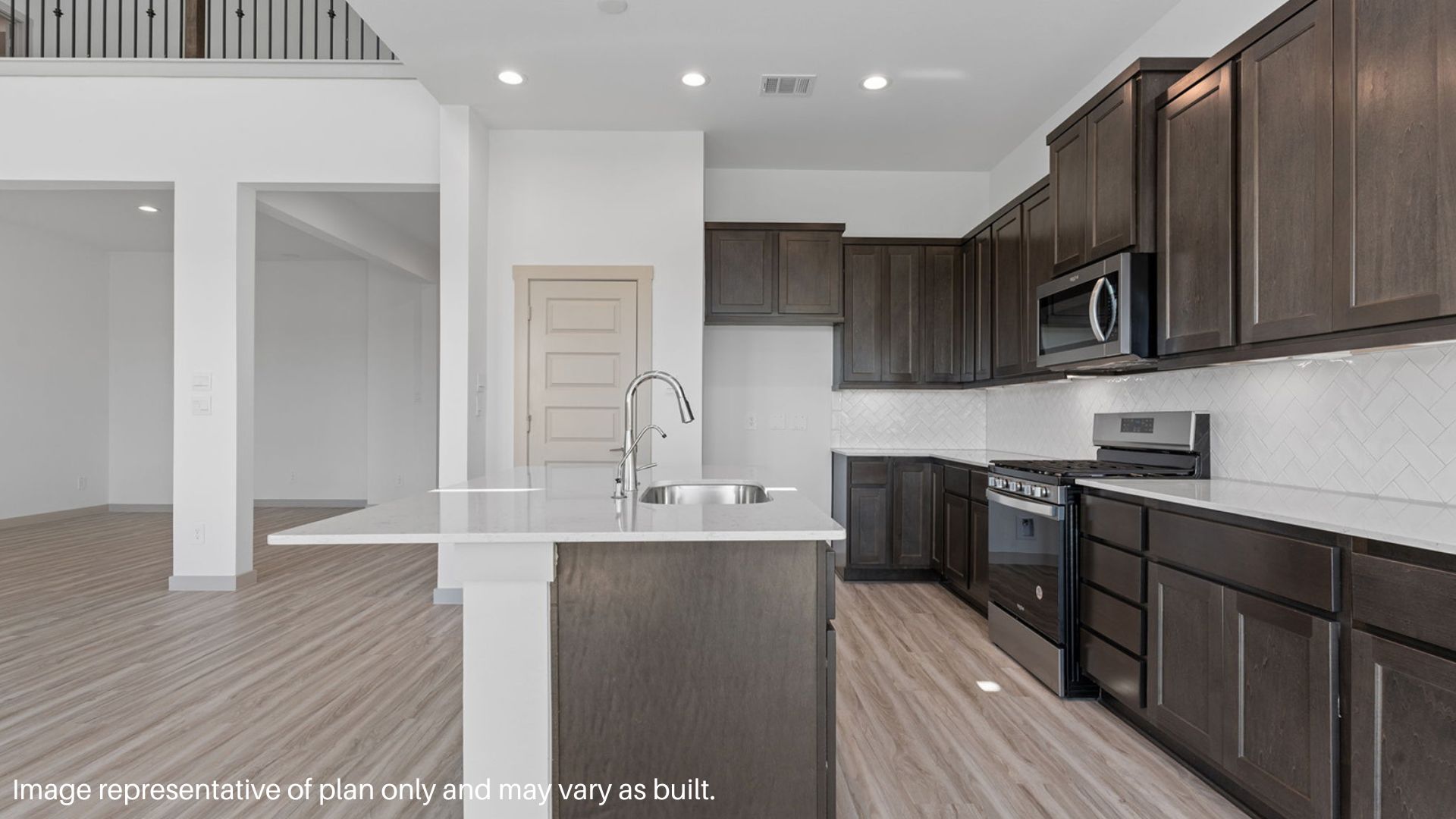 Kitchen with island and stainless-steel appliances.