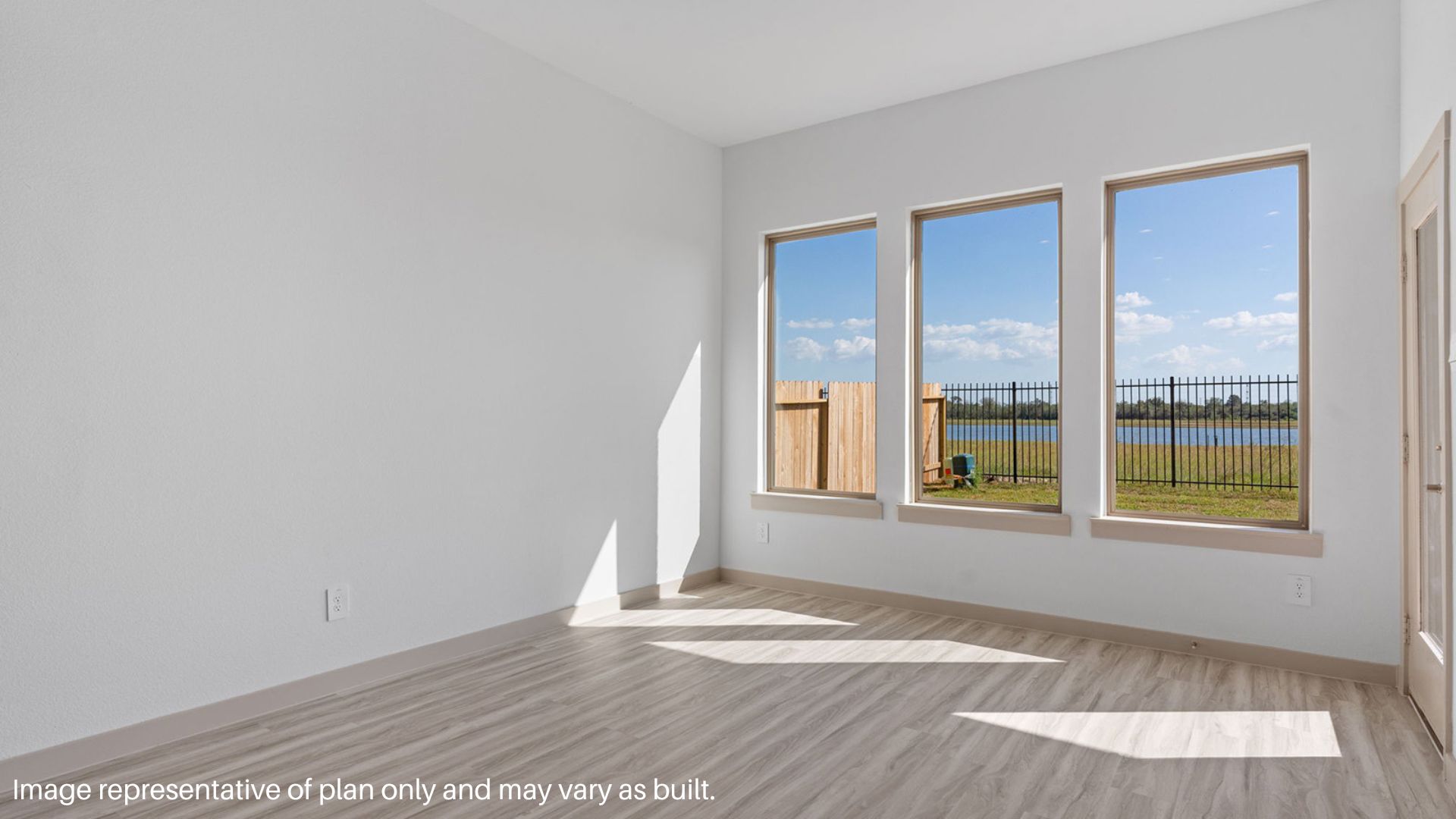 Breakfast nook with vinyl flooring and large windows.