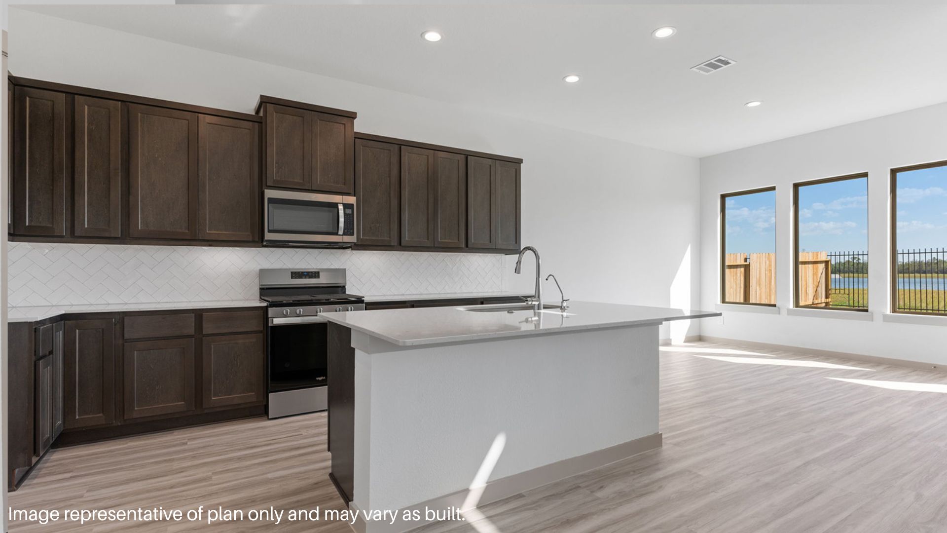 Kitchen with island and stainless-steel appliances.