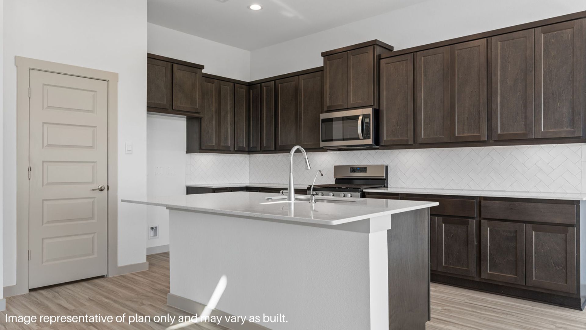 Kitchen with island and stainless-steel appliances.