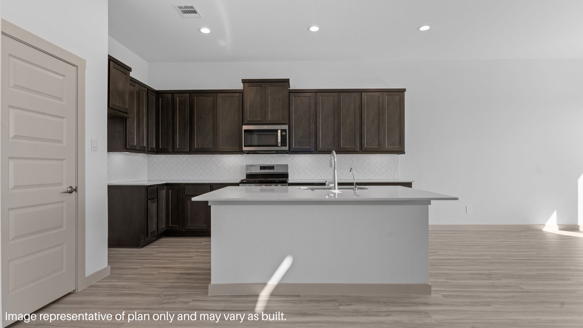 Kitchen with island and stainless-steel appliances.