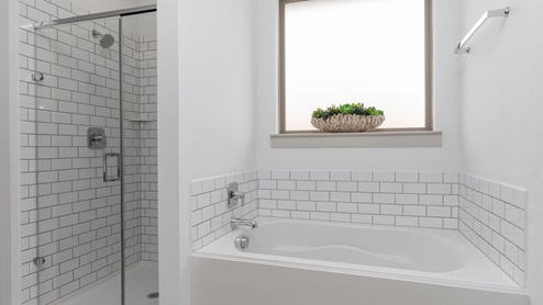 Primary bathroom separate bathtub and shower
