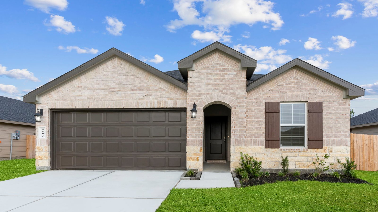 single story brick home with a two car garage