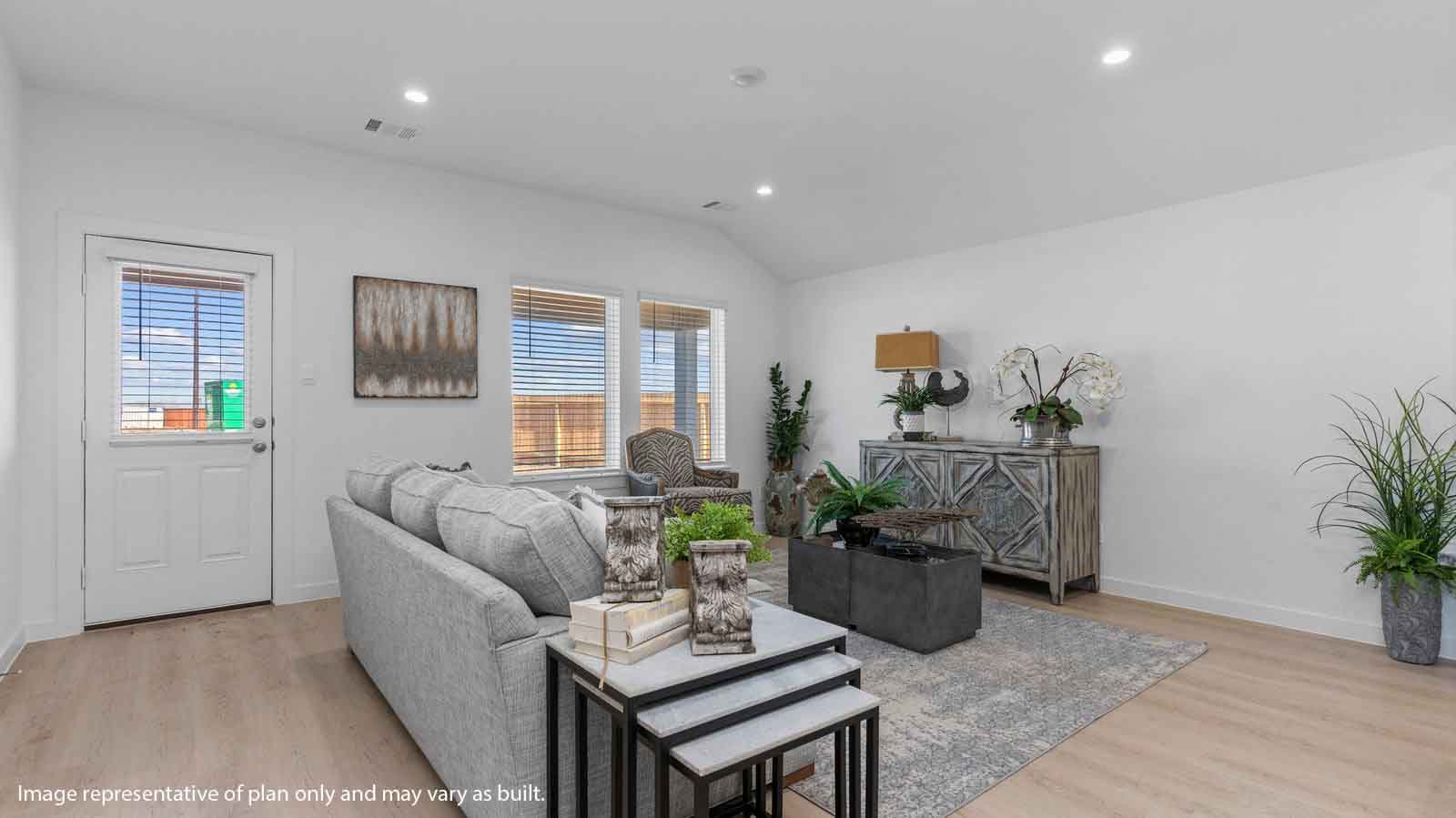 Spacious living room with back patio door and two large windows